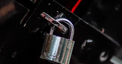 A metal padlock securing a latch, representing encrypted data and digital privacy