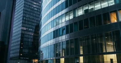 Glass corporate office towers in a financial district at dusk, illustrating the JPMorgan retaliation lawsuit