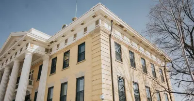 The columned facade of a courthouse, representing the legal dispute over professional licensing as the DOJ sues New Mexico