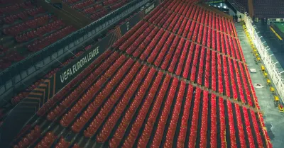 Rows of empty seats in a football stadium, illustrating scrutiny of Premier League crypto sponsors and club sponsorship deals