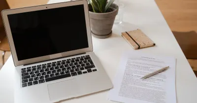 Legal documents beside a laptop displaying AI technology, illustrating artificial intelligence use in legal research