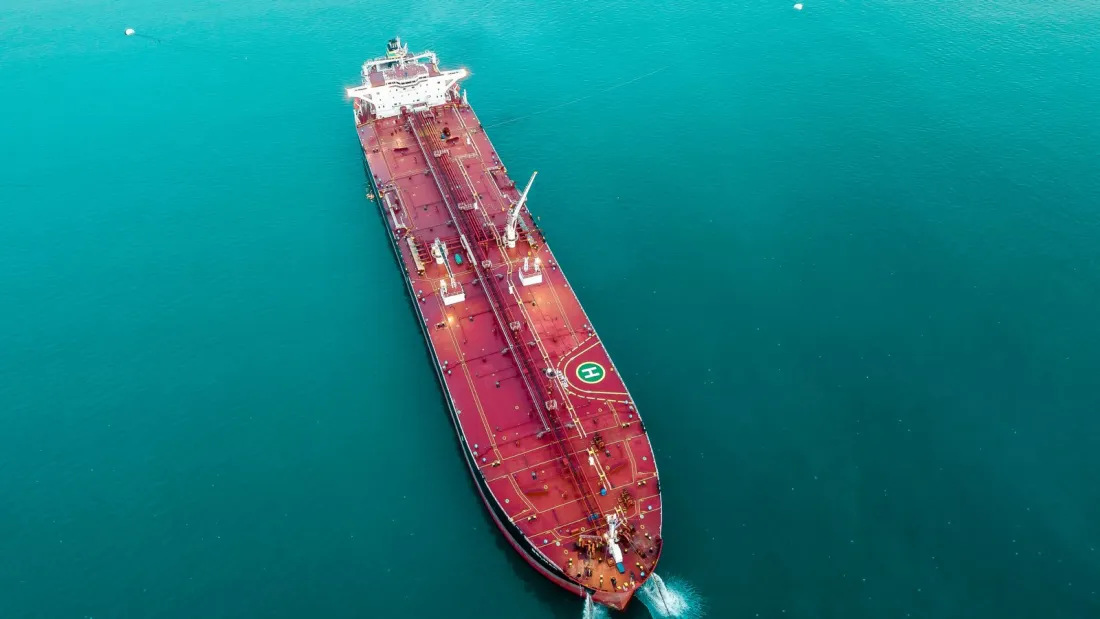 Aerial view of an oil tanker at sea, illustrating what secondary sanctions on Iran mean for shipping and trade