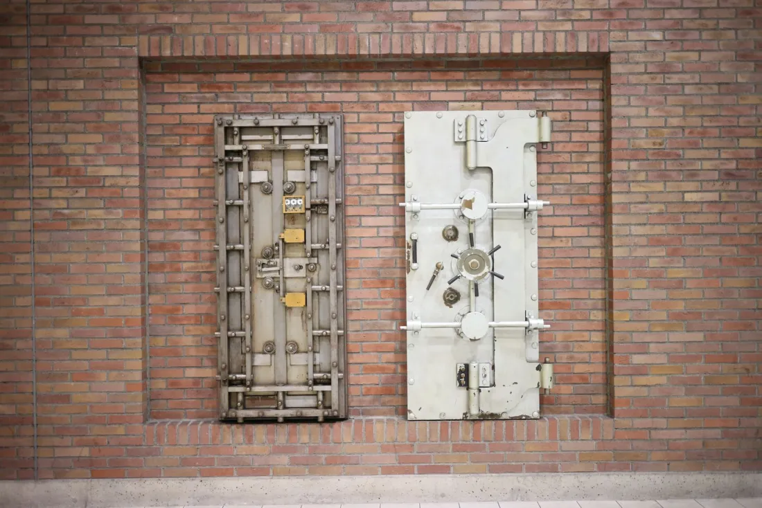 Two steel vault doors set into a brick wall, representing execution immunity that protects state assets after an arbitral award is enforced