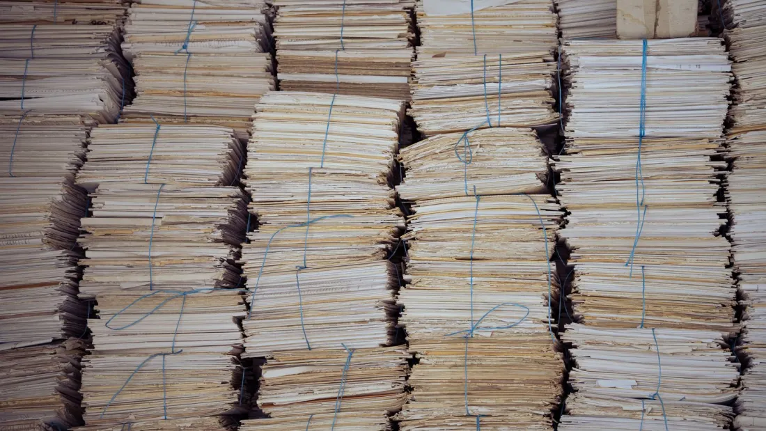 Bundles of paper records tied with string, illustrating creditor claims handled under the Malaysia Cross-Border Insolvency Act 2026