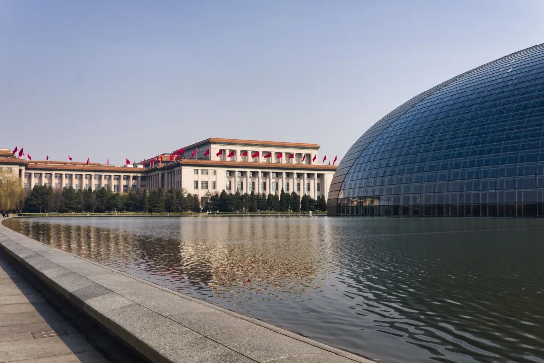 Great Hall of the People in Beijing beside a reflecting lake, where China's legislature is reviewing the draft anti-cross-border corruption law
