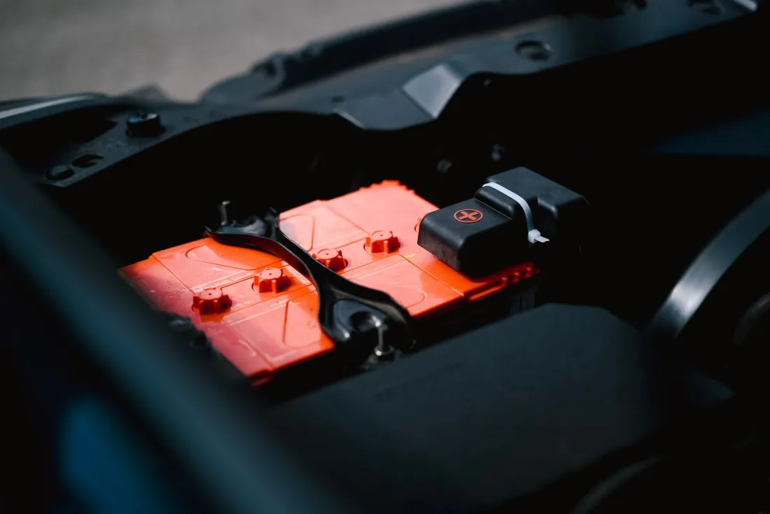 Car starter battery in an engine bay, illustrating how EU cartel fines are calculated in the automotive battery cartel