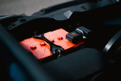 Car starter battery in an engine bay, illustrating how EU cartel fines are calculated in the automotive battery cartel