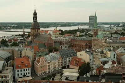 Aerial view of Riga Old Town rooftops and the Daugava river, illustrating whether you can get residency in Latvia if you buy a house