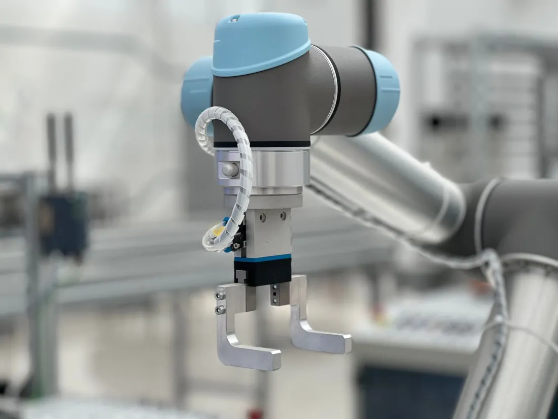 Industrial robotic arm on a production line, illustrating AI in regulated products under the EU AI Act high-risk rules