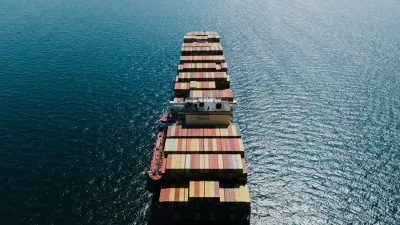 Aerial view of a loaded container ship at sea, illustrating the status of IEEPA refunds for importers