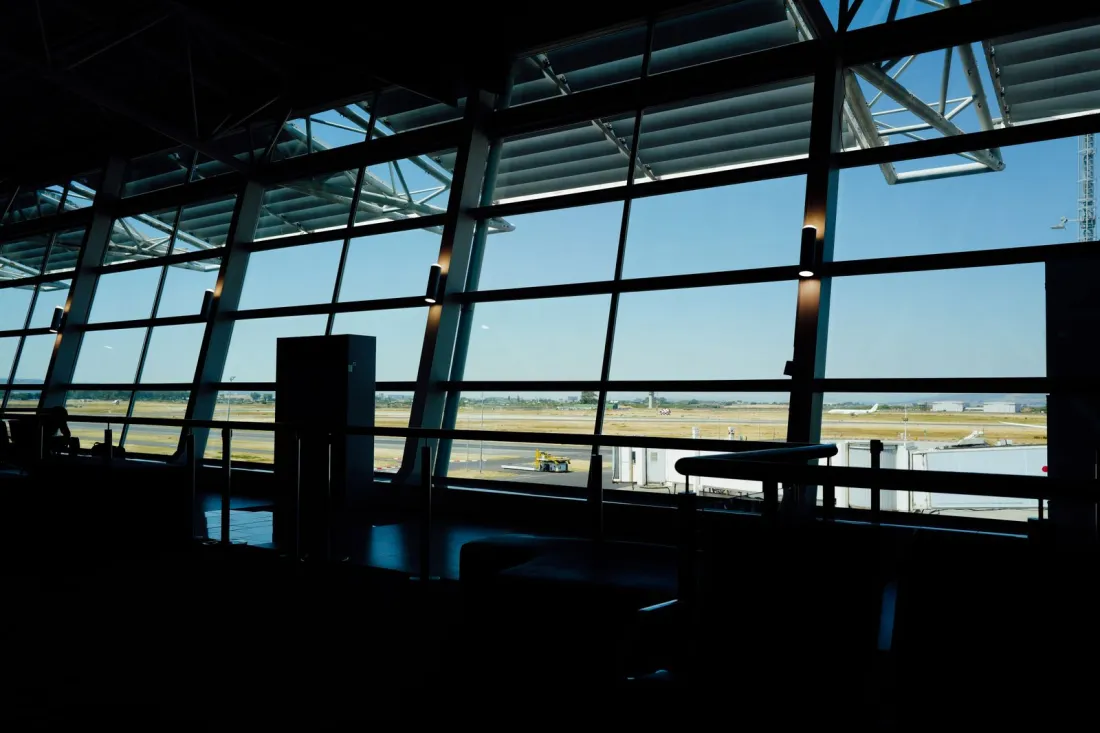 Empty airport departure lounge overlooking the runway, illustrating how long you have to live outside the UK to avoid inheritance tax