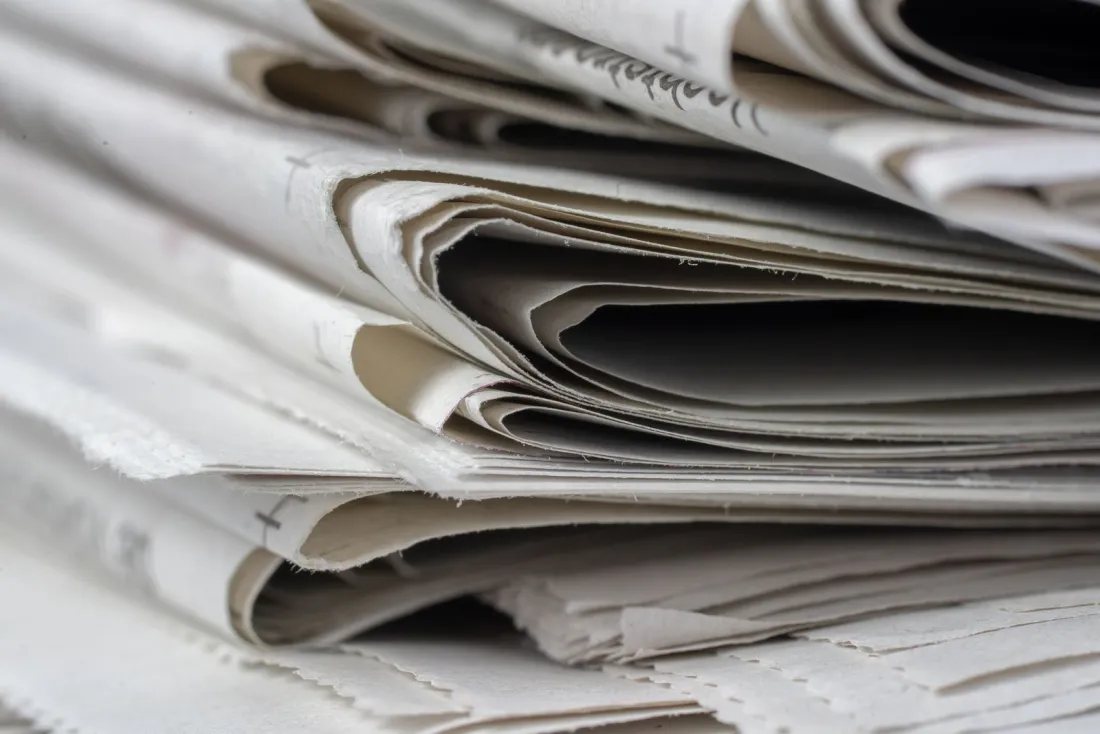 Close-up of a stack of folded newspapers, representing the publishers affected by the Google ad tech antitrust remedies