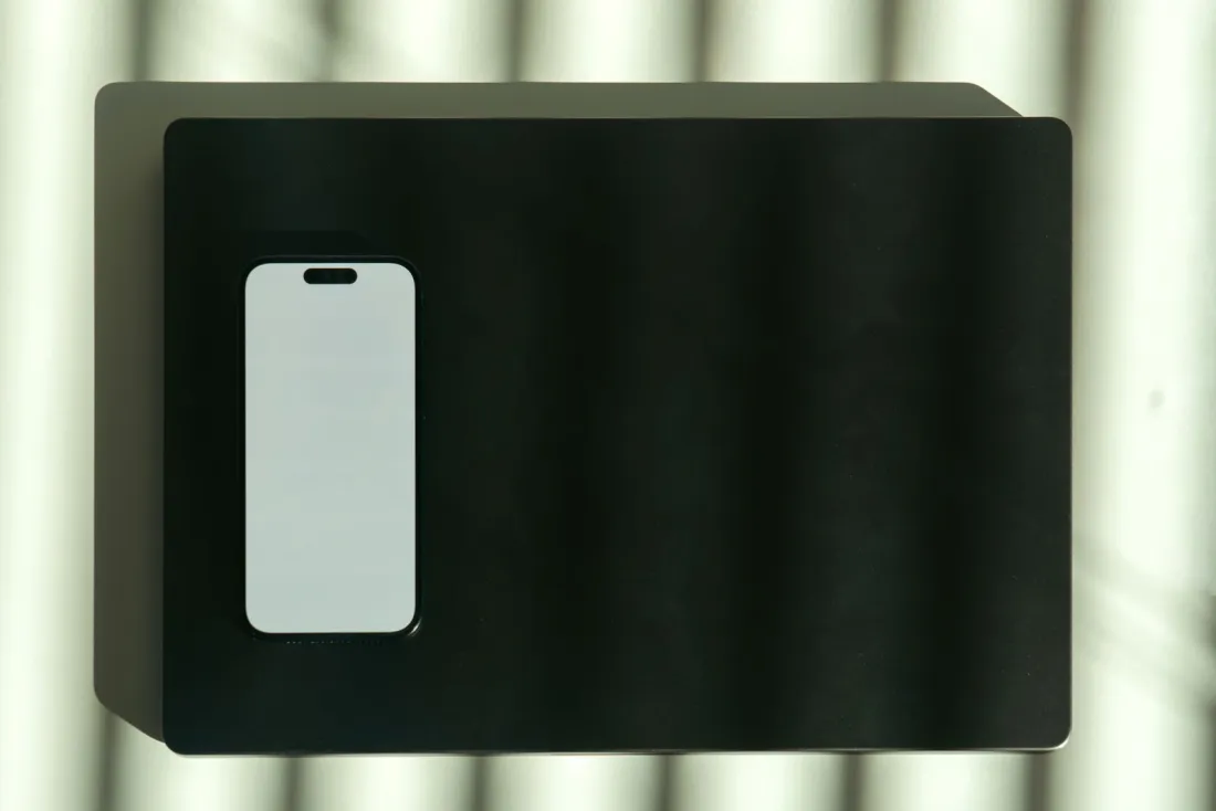 Smartphone with a blank screen on a dark desk, illustrating Apple Advanced Data Protection in the UK and the Home Office demand for iCloud access