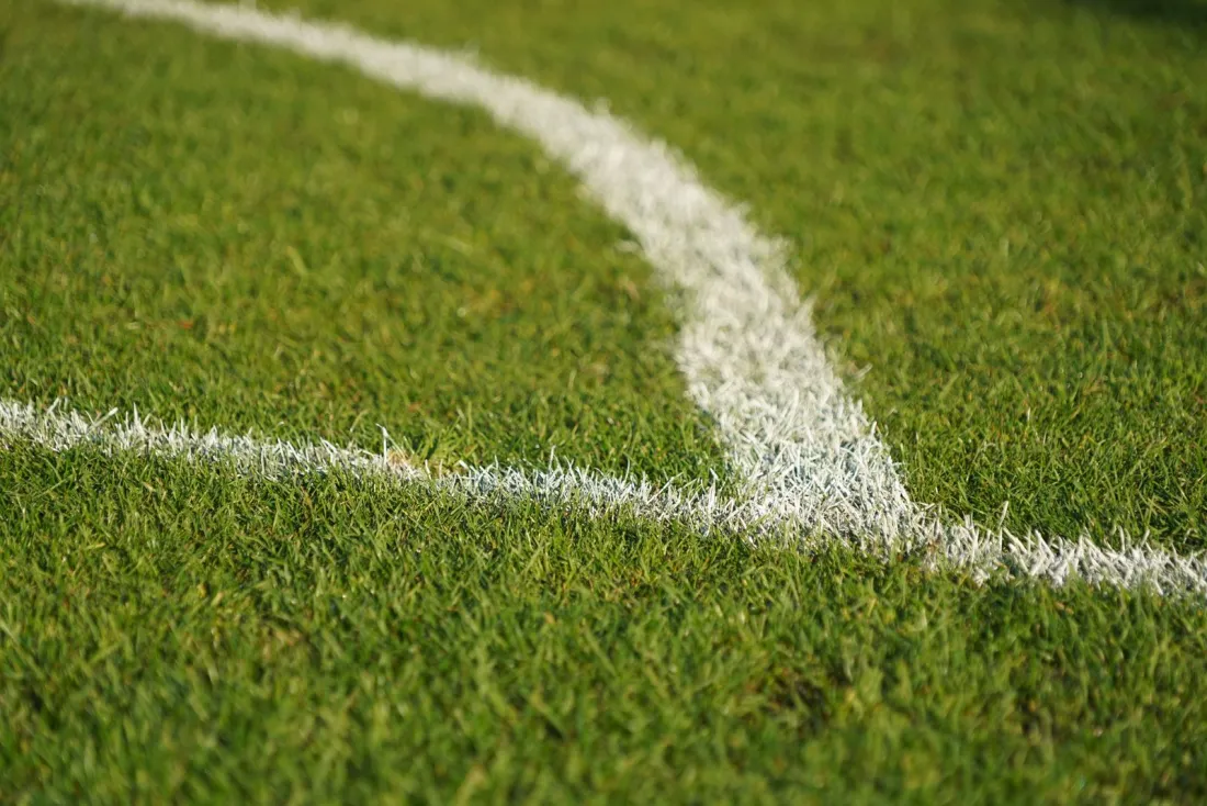Close-up of a white line on a football pitch, symbolising the Premier League appeal board process in the Man City appeal