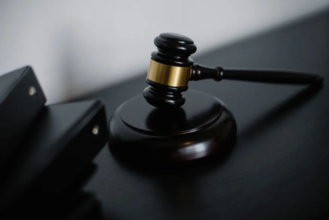 Wooden gavel beside legal folders, representing whether a jury verdict can be reversed by post-trial motions in the Apple Taction case