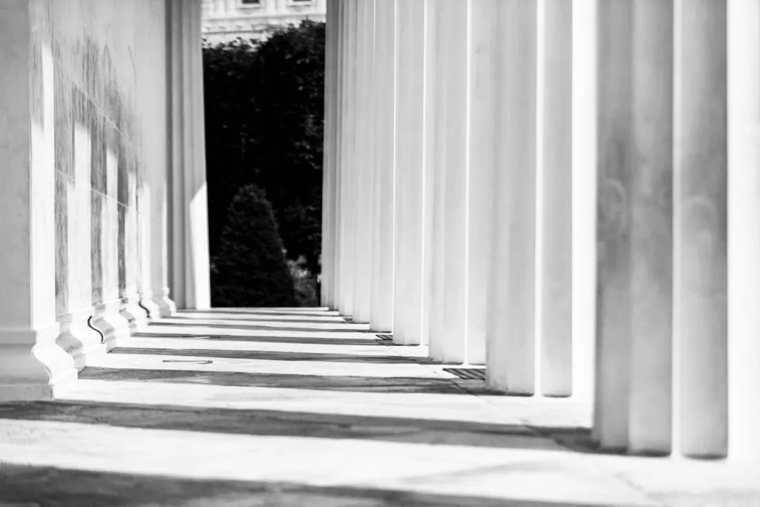 Row of classical columns casting shadows, representing the Federal Circuit appeal of the Apple patent verdict
