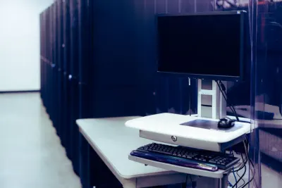Data centre server racks beside a workstation, illustrating whether Google shares your search history under the EU Digital Markets Act