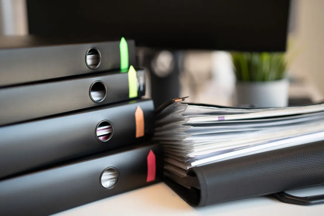 Ring binders and court papers on a desk, illustrating new Business and Property Division claim form titles