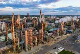 Aerial view of an oil refinery at sunset, illustrating whether oil companies can be sued for climate change