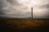 Telecoms mast and equipment hut on open ground under a heavy sky, illustrating whether MTN is being sued under the US Anti-Terrorism Act