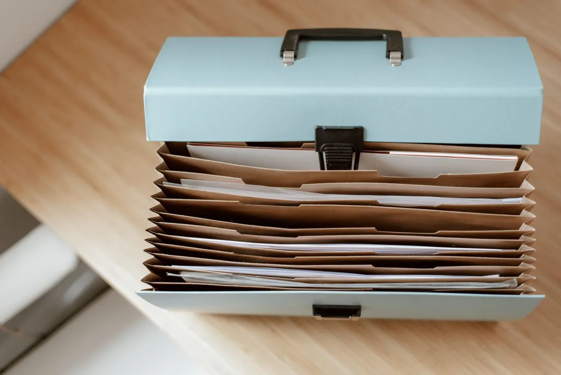 Open document file box on a desk, illustrating the records compliance teams need to manage Anti-Terrorism Act corporate liability