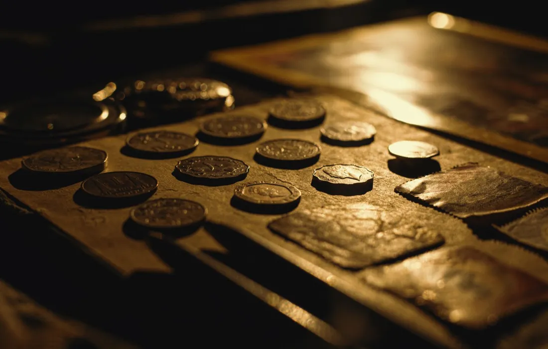Coins on a table in warm light, representing the damages claimed in the Google Play Store class action lawsuit