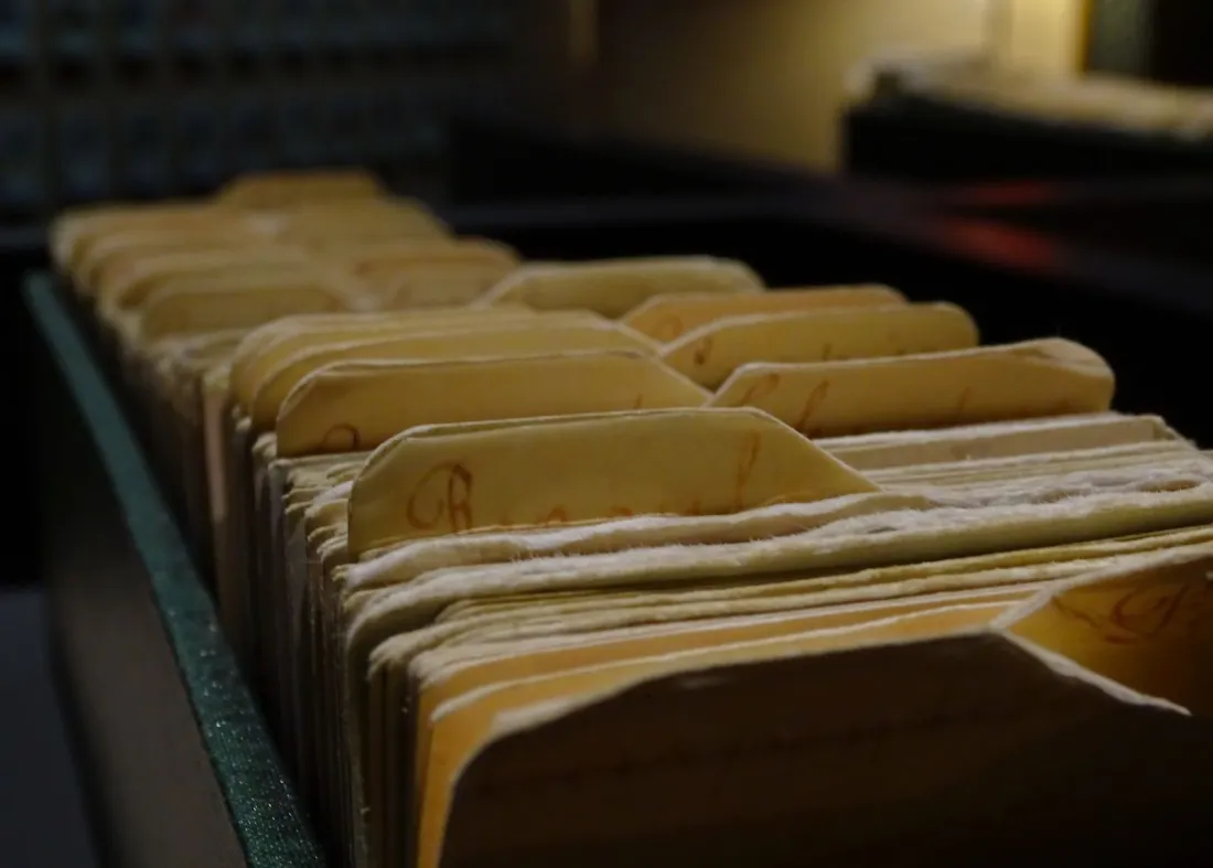 Rows of paper file folders in an archive, representing the Ofcom information notices Meta, X and TikTok are challenging under the Online Safety Act