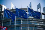 EU flags flying outside the European Parliament in Strasbourg, illustrating MiCA licence requirements for crypto firms in the EU