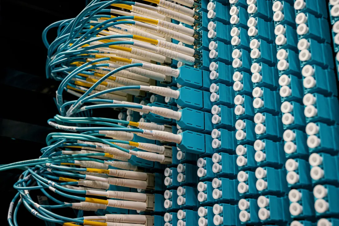Fibre optic cables in a data centre patch panel, illustrating the crypto travel rule and data flows under MiCA licence requirements