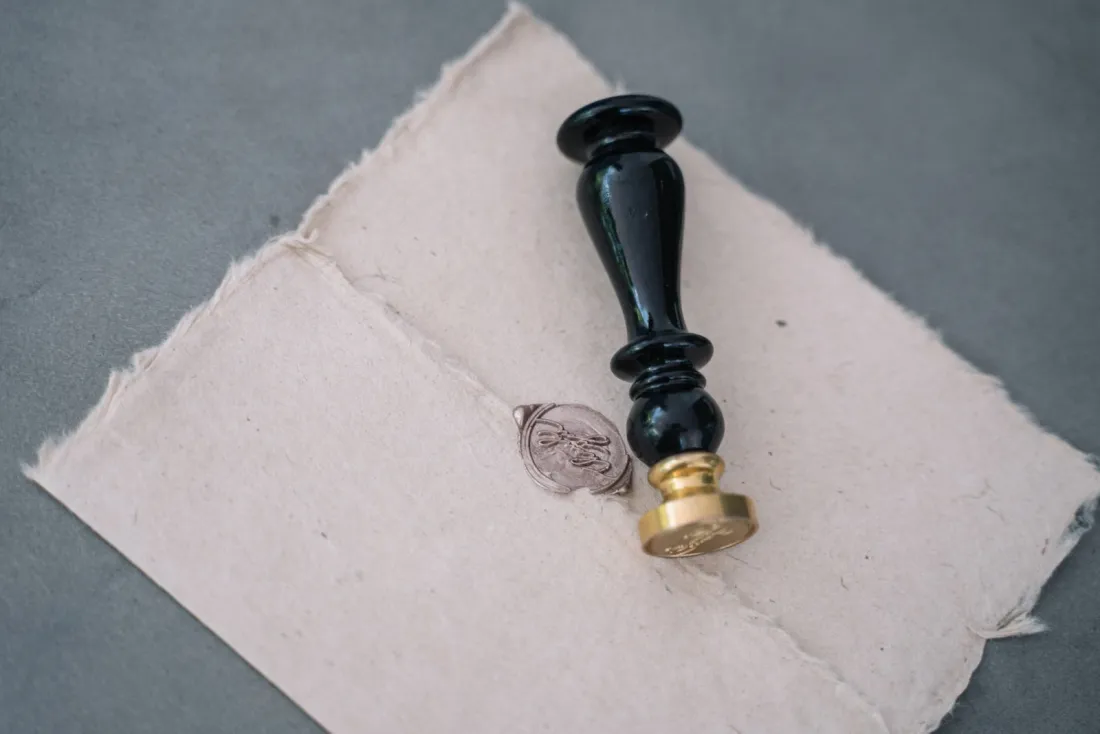 Wax seal and stamp on handmade paper, illustrating the certified documents needed when registering a foreign judgment in England