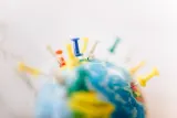Globe studded with coloured push pins, illustrating the branch vs subsidiary decision when expanding a business abroad