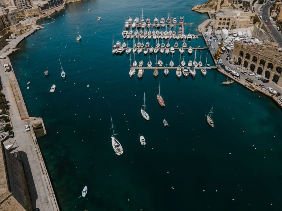 Aerial view of yachts moored in a Mediterranean marina, illustrating offshore assets in an international divorce