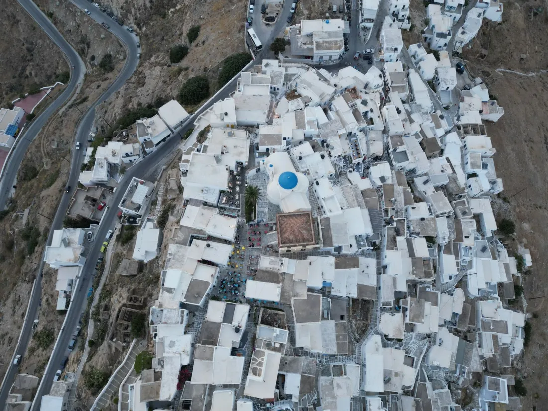 Aerial view of whitewashed houses on a Greek island hillside, illustrating where foreigners can buy property abroad in Europe