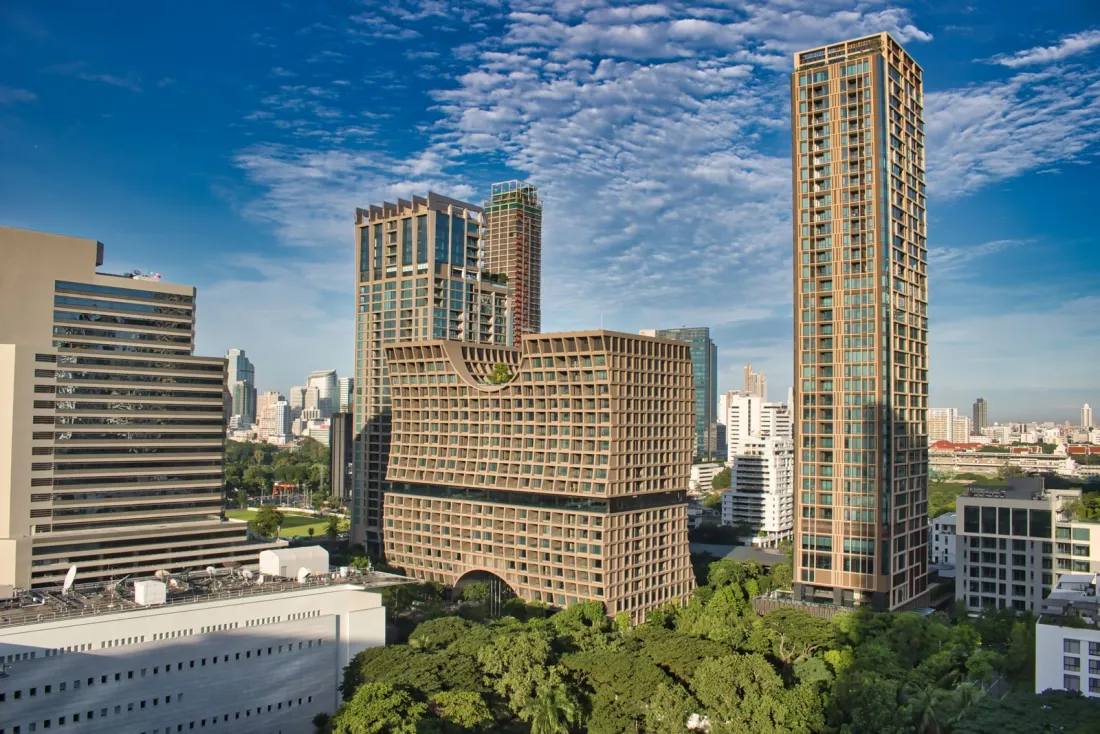Residential condominium towers above trees in central Bangkok, illustrating the foreign condominium quota for buyers in Thailand