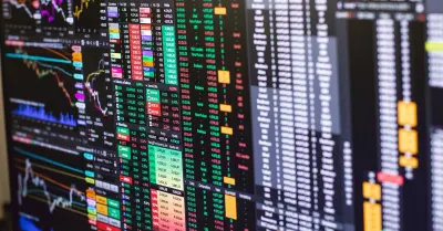 Financial market data and share price charts displayed on a trading screen