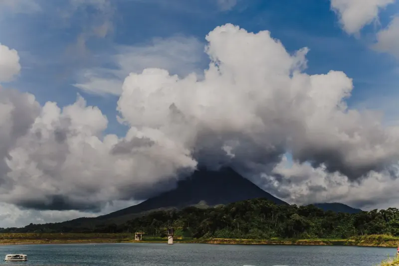 Arenal Volcano under billowing clouds above Lake Arenal, Costa Rica: lawyers and advisers in Costa Rica