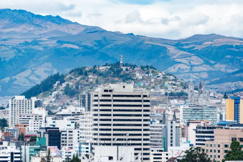 Quito city buildings and El Panecillo hill with the Andes behind, Ecuador: lawyers and advisers in Ecuador