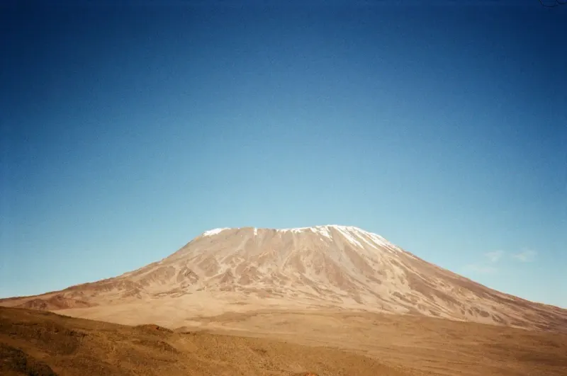 Snow-capped summit of Mount Kilimanjaro under a clear blue sky, Tanzania: lawyers and advisers in Tanzania