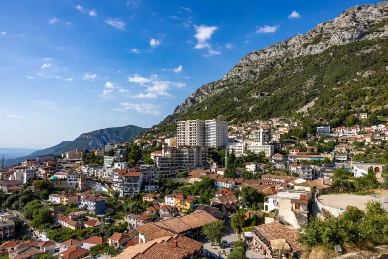 The town of Krujë on a mountainside under a blue sky, Albania: lawyers and advisers in Albania