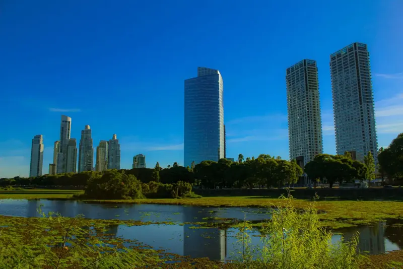 Buenos Aires skyscrapers reflected in a pond under a blue sky, Argentina: lawyers and advisers in Argentina