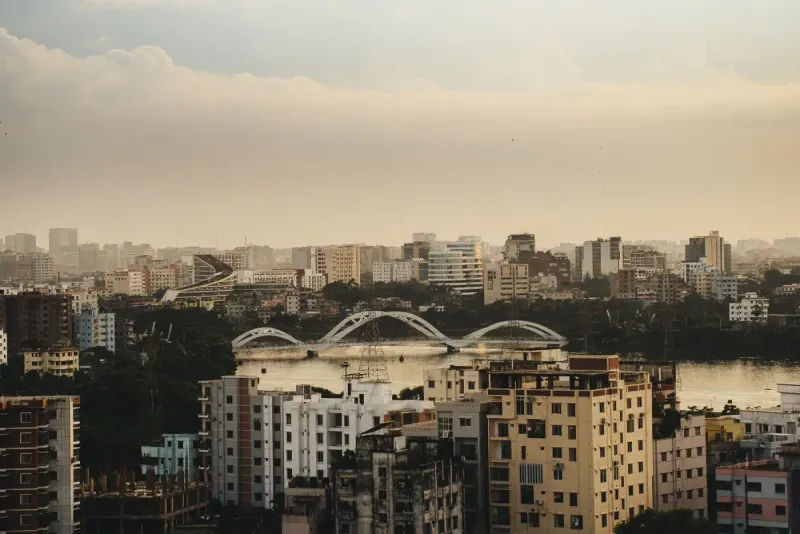 Dhaka skyline with an arched bridge over the water at sunset, Bangladesh: lawyers and advisers in Bangladesh