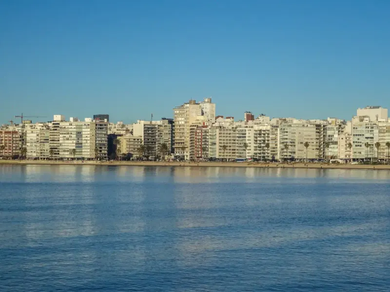 Montevideo waterfront apartment skyline across calm water, Uruguay: lawyers and advisers in Uruguay