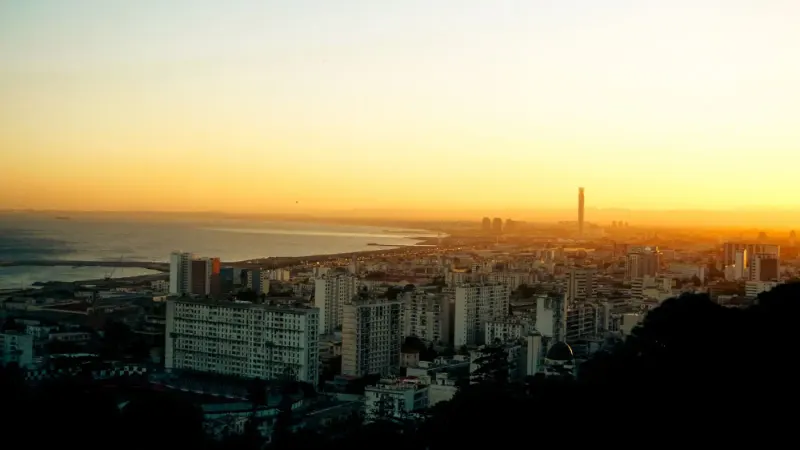 Algiers cityscape and bay under a golden sunrise sky, Algeria: lawyers and advisers in Algeria