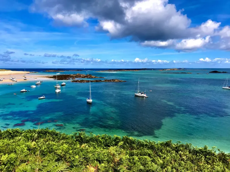 Sailing boats in turquoise water off Herm, Bailiwick of Guernsey: lawyers and advisers in Guernsey
