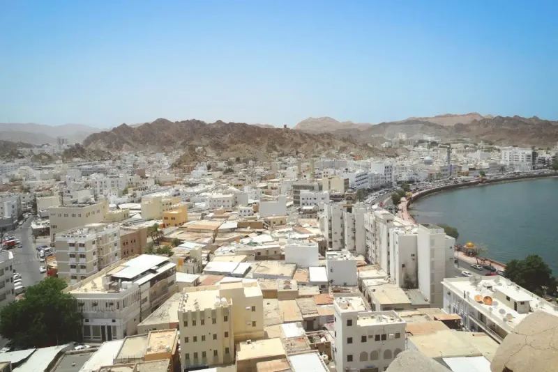 Aerial view of Muscat between the coast and mountains, Oman: lawyers and advisers in Oman