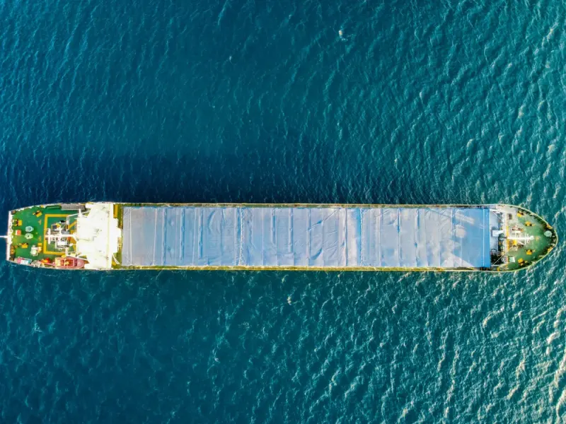Top-down aerial view of a cargo ship on the open sea: maritime & shipping news and analysis
