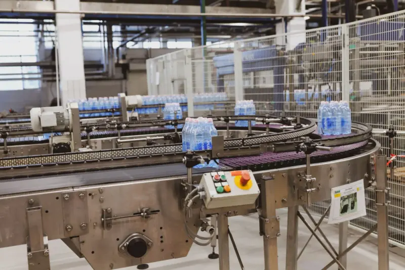 Bottled water moving along an automated factory conveyor: product liability lawyers and advisers