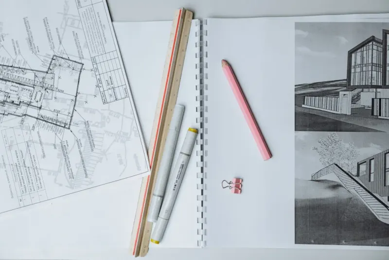 Architectural blueprints, ruler and drawing tools on a desk: project management experts and advisers