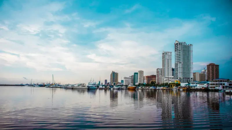Manila Bay marina and city skyline reflected in calm water, Philippines: lawyers and advisers in the Philippines
