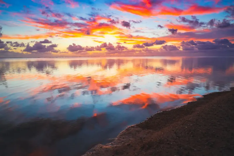 Sunset sky reflected in still water off a beach on Saipan, Northern Mariana Islands: lawyers and advisers in the Northern Mariana Islands